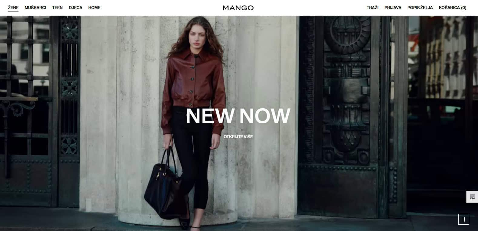 Žena u kožnoj jakni i crnim hlačama naslonjena na zid